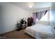 Bedroom featuring carpeted floor, ceiling fan, a window, and a modern dresser at 6337 N 49Th Ave, Glendale, AZ 85301
