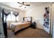 Cozy bedroom with a ceiling fan, a large window, and ample closet space at 6337 N 49Th Ave, Glendale, AZ 85301