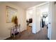 Hallway with neutral carpet and a view into two bedrooms. Features a glass table and decorations at 6337 N 49Th Ave, Glendale, AZ 85301