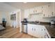 Bright kitchen with stainless steel appliances, white cabinets, and wood flooring at 6337 N 49Th Ave, Glendale, AZ 85301