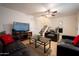 Cozy living room with leather furniture, a flat screen TV and wood flooring at 6337 N 49Th Ave, Glendale, AZ 85301