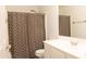 Bright bathroom featuring a stylish vanity, updated fixtures, and a shower-tub combination with a modern curtain at 10649 W Monte Vista Rd, Avondale, AZ 85392