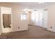 Large bedroom with neutral tones, a ceiling fan, and an attached bathroom with updated fixtures for added privacy at 10649 W Monte Vista Rd, Avondale, AZ 85392