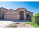 Charming home featuring a two-car garage, desert landscaping, and a secure screen door for added security at 10649 W Monte Vista Rd, Avondale, AZ 85392