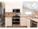 Updated kitchen featuring stainless steel appliances, neutral countertops, and ample storage space for modern living at 10649 W Monte Vista Rd, Avondale, AZ 85392