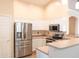 Modern kitchen featuring stainless steel appliances, sleek white cabinetry, and a functional layout perfect for cooking at 10649 W Monte Vista Rd, Avondale, AZ 85392