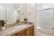 Bathroom featuring warm cabinetry and tile, and a large mirror at 8167 E Sand Flower Dr, Scottsdale, AZ 85266