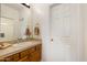 Bathroom featuring warm cabinetry and tile, and a large mirror at 8167 E Sand Flower Dr, Scottsdale, AZ 85266