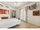 Bright bedroom featuring tile floors, ceiling fan, and double doors to the outside at 8167 E Sand Flower Dr, Scottsdale, AZ 85266
