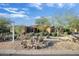 Home's exterior shows desert landscaping, mature trees, and signage at 8167 E Sand Flower Dr, Scottsdale, AZ 85266