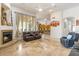 Spacious living room with fireplace, tile floors, and kitchen access at 8167 E Sand Flower Dr, Scottsdale, AZ 85266