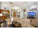 Open-concept living space with a bar, media center, tile flooring, and ample seating at 8167 E Sand Flower Dr, Scottsdale, AZ 85266