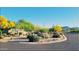 Well-maintained community entrance with mature desert landscaping at 8167 E Sand Flower Dr, Scottsdale, AZ 85266