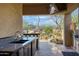 Well-equipped outdoor kitchen with stainless steel appliances and views of the desert landscape at 8167 E Sand Flower Dr, Scottsdale, AZ 85266