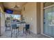 Covered patio with bar, seating, and a mounted television at 8167 E Sand Flower Dr, Scottsdale, AZ 85266
