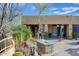 Comfortable desert landscaping with a covered patio and a tile-topped stone table at 8167 E Sand Flower Dr, Scottsdale, AZ 85266