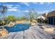 Inviting pool area with mature desert landscaping, including a hot tub and a comfortable seating area at 8167 E Sand Flower Dr, Scottsdale, AZ 85266