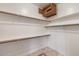 Spacious walk-in closet featuring built-in shelving and wood rods with a safe at 8167 E Sand Flower Dr, Scottsdale, AZ 85266