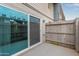 Back patio with wooden fence and large sliding glass door to the home at 2610 W Berridge Ln # C115, Phoenix, AZ 85017