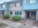 Charming townhome with appealing blue and gray exterior, manicured landscaping, and convenient carport at 2610 W Berridge Ln # C115, Phoenix, AZ 85017