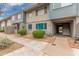 Charming two-story condo unit with light blue and gray siding and landscaping at 2610 W Berridge Ln # C115, Phoenix, AZ 85017