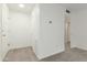 Hallway entry featuring a front door and coat closet, adjacent to a bathroom at 2610 W Berridge Ln # C115, Phoenix, AZ 85017