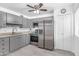 Kitchen featuring gray cabinets, stainless steel appliances, and quartz countertops at 2610 W Berridge Ln # C115, Phoenix, AZ 85017