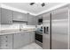 Kitchen featuring stainless steel refrigerator and gray cabinets at 2610 W Berridge Ln # C115, Phoenix, AZ 85017