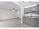 Bright kitchen and dining area with modern gray cabinetry and granite countertops at 2610 W Berridge Ln # C115, Phoenix, AZ 85017