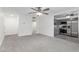 Spacious living room featuring a ceiling fan, adjacent kitchen, and tile flooring at 2610 W Berridge Ln # C115, Phoenix, AZ 85017