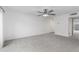 Carpeted living room with neutral color, large entry to kitchen and exterior access at 2610 W Berridge Ln # C115, Phoenix, AZ 85017