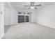 Living room with neutral carpet, brick wall, ceiling fan and fenced patio visible at 2610 W Berridge Ln # C115, Phoenix, AZ 85017