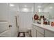 Well-lit bathroom features double vanity, shower with curtain and white cabinets at 1157 W Paradise Way, Casa Grande, AZ 85122