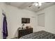 Bright bedroom featuring a black dresser, television, and carpeted floors at 1157 W Paradise Way, Casa Grande, AZ 85122