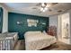 Bright bedroom with a ceiling fan, natural light, a crib and unique decor elements at 1157 W Paradise Way, Casa Grande, AZ 85122