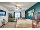 Bright bedroom with a ceiling fan, natural light and unique decor elements at 1157 W Paradise Way, Casa Grande, AZ 85122