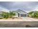 Single-story home featuring a two-car garage, tidy landscaping, and modern architectural accents at 1157 W Paradise Way, Casa Grande, AZ 85122