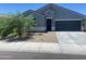 Inviting single-story home featuring a two-car garage, neutral colors, and desert landscaping in front at 1157 W Paradise Way, Casa Grande, AZ 85122