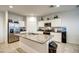 Modern kitchen with stainless steel appliances, granite countertops, and a functional center island at 1157 W Paradise Way, Casa Grande, AZ 85122