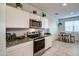 Bright kitchen featuring stainless steel oven, microwave and granite countertop at 1157 W Paradise Way, Casa Grande, AZ 85122