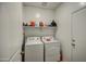 Practical laundry room features modern washer and dryer, plus shelving for storage at 1157 W Paradise Way, Casa Grande, AZ 85122