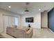 Cozy living room featuring tile flooring, a comfortable sofa, and a ceiling fan with recessed lighting at 1157 W Paradise Way, Casa Grande, AZ 85122