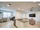 Open floorplan showcasing kitchen island, dining, and living areas with tile flooring at 1157 W Paradise Way, Casa Grande, AZ 85122