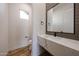 Modern powder room with a marble countertop, black fixtures, and contemporary design at 1101 E Dolores Rd, Phoenix, AZ 85086