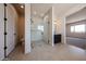 Spa-like bathroom with tile flooring, a glass shower, and a dark vanity at 1101 E Dolores Rd, Phoenix, AZ 85086