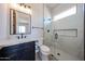 Modern bathroom featuring a glass shower, marble countertops, and sleek black fixtures at 1101 E Dolores Rd, Phoenix, AZ 85086