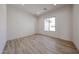 Cozy bedroom showcasing wood-look tile flooring and a bright window at 1101 E Dolores Rd, Phoenix, AZ 85086