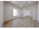 Simple bedroom featuring wood-look tile floors, a window, and white walls at 1101 E Dolores Rd, Phoenix, AZ 85086