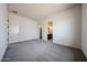 Spacious carpeted bedroom showcases doorways to ensuite and closet, offering functional and private spaces at 1101 E Dolores Rd, Phoenix, AZ 85086