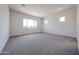 Spacious bedroom with plush carpeting, recessed lighting, and bright natural light at 1101 E Dolores Rd, Phoenix, AZ 85086